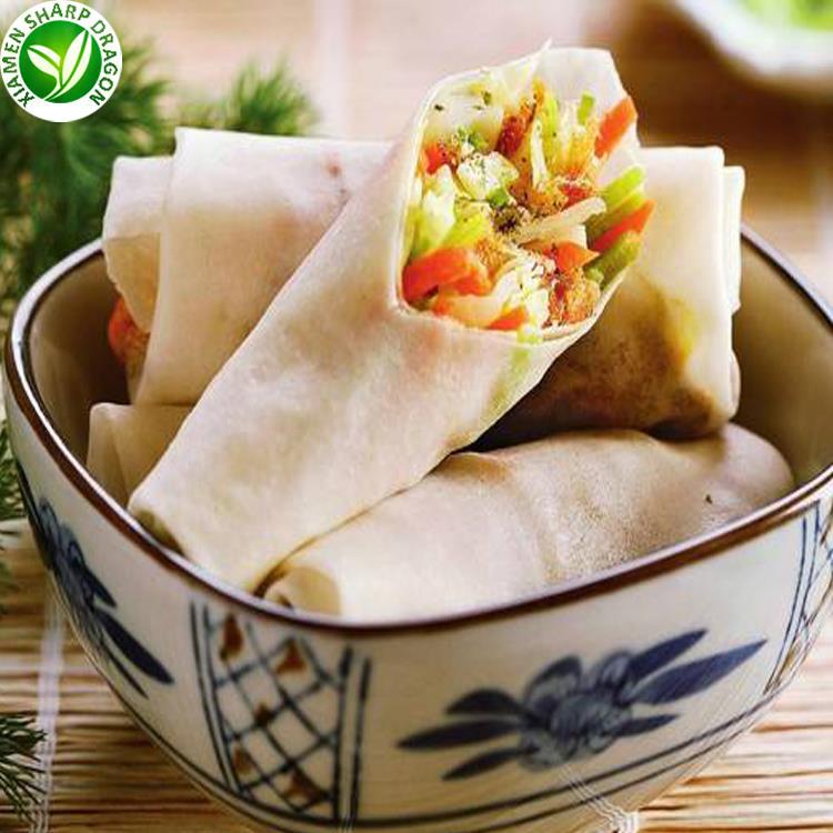 A spring roll includes both wrapper and filling Spring rolls in a bowl with one cut roll showing vegetable filling